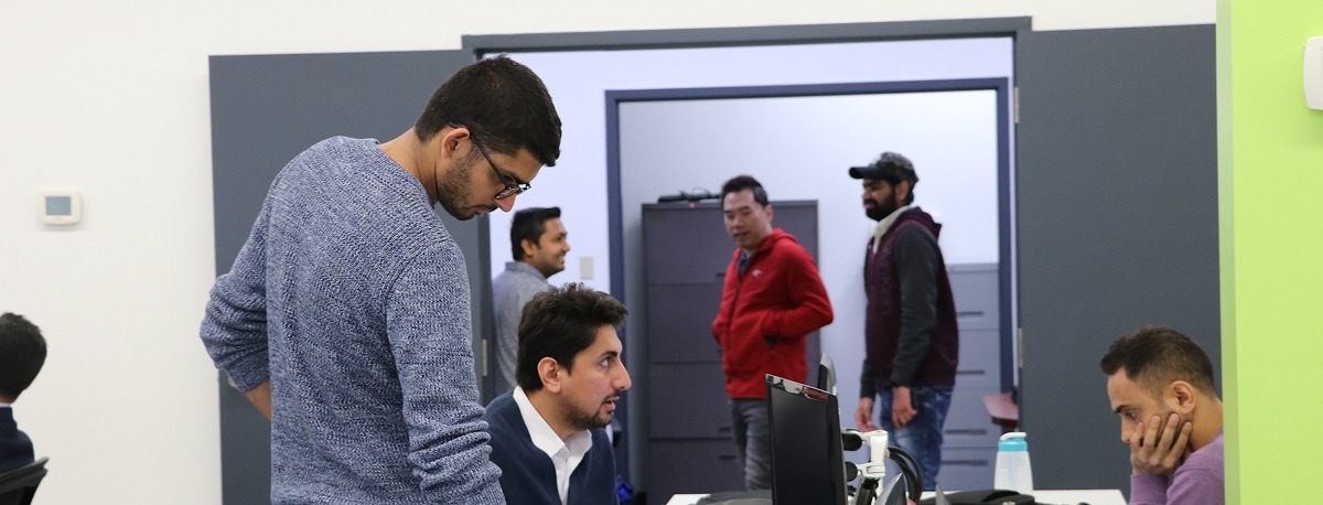 ML arteka team collaborating at workstations, representing practitioner-led engineering